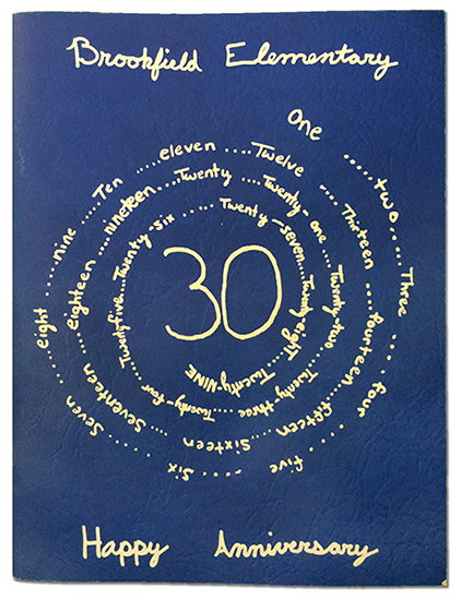 Color photograph of the cover of Brookfield's 1998 yearbook. The cover is blue with the name Brookfield, the number 30, and the words Happy Anniversary written in cursive.