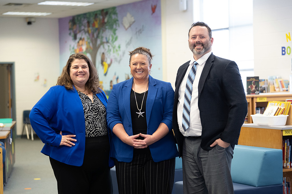 Three administrators in the library