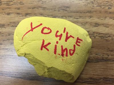 A rock with "you're kind" written on it.